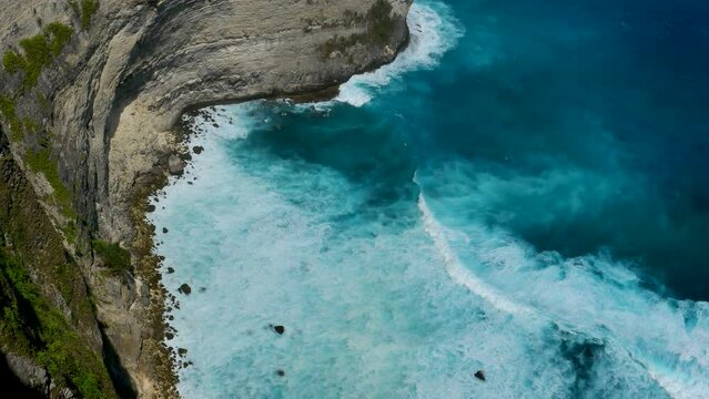 Turquoise ocean sea water white wave pattern splashing deep blue sea. Seascape dark ocean background wave splash on rock. Tropical sea beach in summer seaside outdoor. Water Surface blue wave pattern