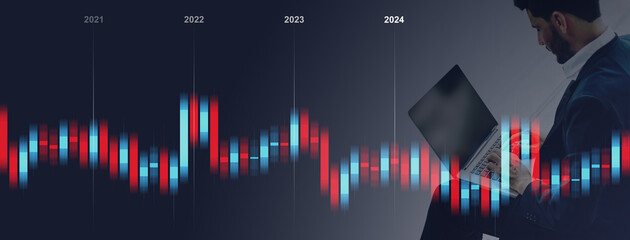 Businessman Analyzing Stock Market Trends on Laptop with Graph Overlay from 2021 to 2024. Professional investment, experience economy, Finance and Business Technology Concept.