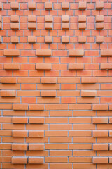 Background and Texture of Brick blocks or Red terracotta bricks wall. Beautifully arranged together with sunlight creating image dimension for the exterior building is modern architecture.