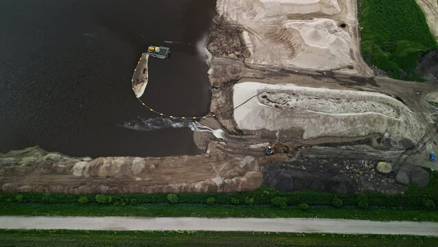 Aerial View of Dredging and Construction Operations at Riverbank including machinery and worksite equipment