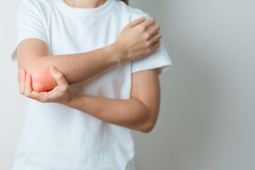 Woman having elbow ache at home, muscle pain due to lateral epicondylitis or tennis elbow. injury, Health and medical concept