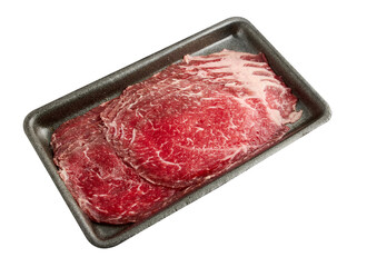 Thinly sliced ​​fresh beef arranged on a black tray isolated on white background.