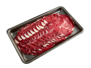 Thinly sliced ​​fresh beef arranged on a black tray isolated on white background.