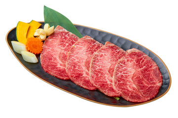 Chuck Eye Sliced is beautifully arranged with a set of vegetables (Slice the pumpkin, garlic, Japanese leeks and carrots) served on a black plate isolated on white background.
