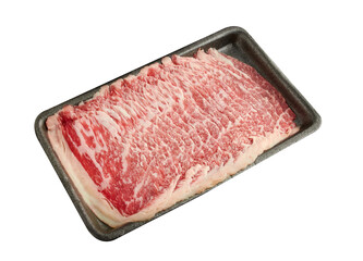 Thinly sliced ​​fresh beef arranged on a black tray isolated on white background.