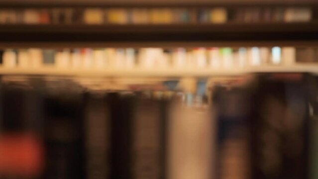 Books in a library from a dolly shot and deep rack focus of 