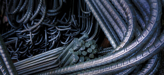 Bent Rebar: Close-up of neatly arranged, various steel reinforcement rods typically used in...