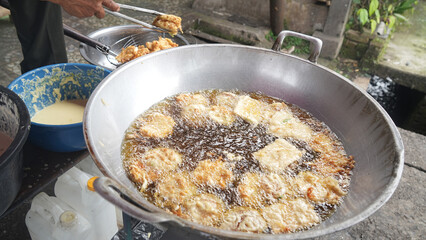 Street food, cooking delicious bakwan goreng, still hot and ready to eat
Bakwan is a fried food made from vegetables and wheat flour. 
