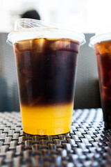 Orange americano coffee on the table. Close up