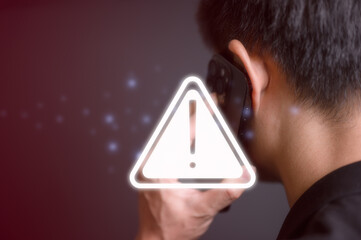 risk and cyber security technology concept man holding mobile phone with alert warning triangle...