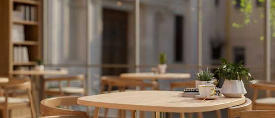 A wooden table with armchairs in a cozy Scandinavian coffee shop or restaurant seating area.