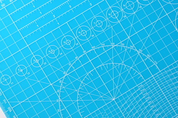 blue cutting mat board background with line and scale measure guide pattern for object art design, tool equipment of diy craft work