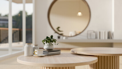 A round wooden coffee table with decorative objects in a modern, Scandinavian living room.