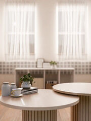 A round wooden coffee table with decorative objects in a modern, Scandinavian living room.