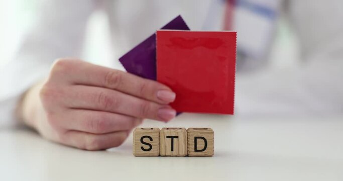 Doctor shows condoms to prevent sexually transmitted diseases