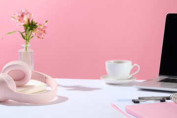 Office theme photo in pink color tone from front angle, blank space in the center of white countertop for product displaying, variety office necessities. Copy space for adding text