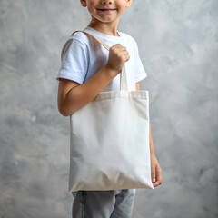 Tote bag mockup. Smiling boy carrying reusable white cotton eco organic fabric canvas blank totebag on grey background. AI generated