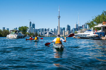 Sea kayakers paddling from the Toronto Islands heading across the harbour toward the downtown city...