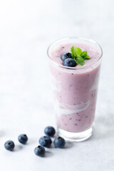 Blueberry smoothie with yogurt in a glass.