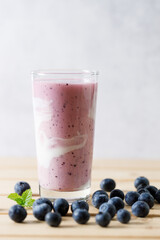 Blueberry smoothie with yogurt in a glass.