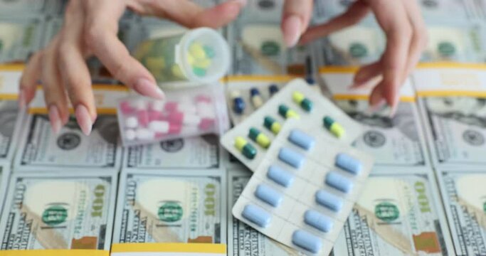 Woman puts capsules onto surface of dollar banknote packs