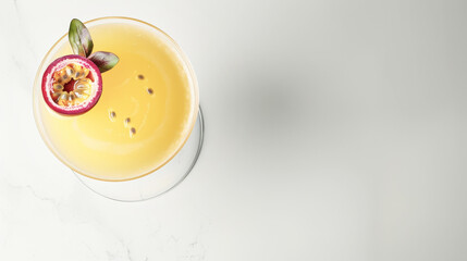 A top view of a passion fruit martini garnished with a passion fruit slice and mint leaves, set against a minimalist white background, ideal for a tropical summer treat