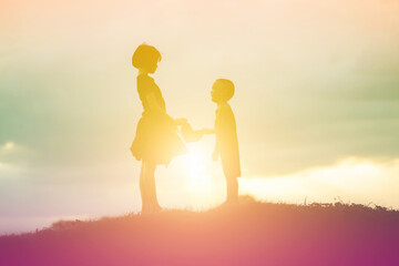 Fototapeta premium silhouette of a happy children and happy time sunset