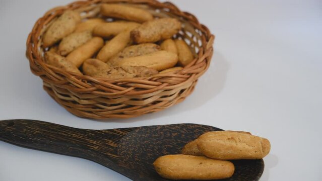 Fresh baked homemade grissini breadsticks in the basket on  kitchen counter top. Bakery galette