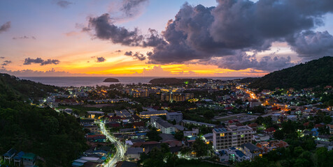 Aerial view Clouds obscure the beautiful sky as the sun sets. The lights along the beach begin to turn on as dusk approaches.There are many buildings, resorts, and hotels that accommodate tourists.