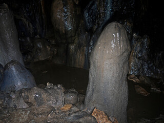 Hiking Inside the Dark cave environment with mineral deposits on the floor and walls
