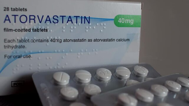 Close-up of statin tablets, medications that lower cholesterol by blocking a substance needed for its production. Atorvastatin, 40mg, medical tablets concept.
