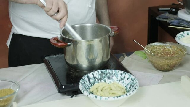 chef cocking on boiling water italian handmade pasta 