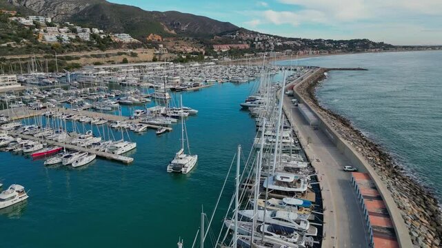 Port ginesta marina with sailboats in a serene coastal setting near barcelona, aerial view