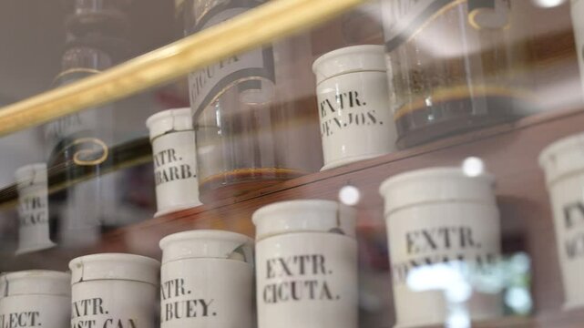 Shelf with old white medicine bottles in a pharmacy
