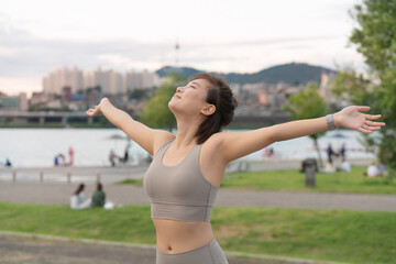 a woman who works out at a riverside park