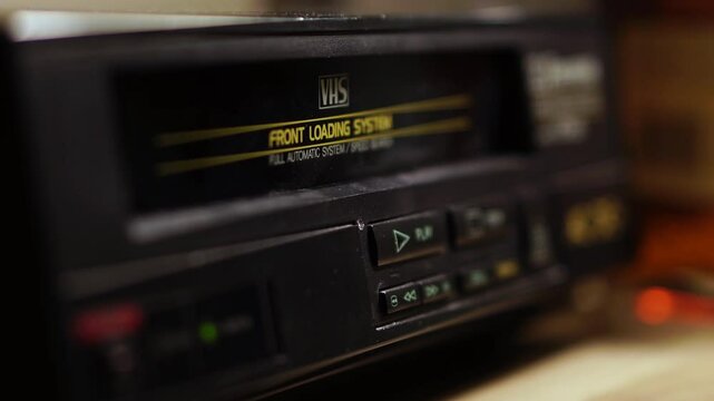 Pressing Stop and Eject Button on VHS Player and Taking Out Video Cassette Tape, Close Up