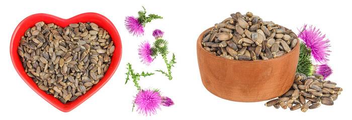 Seeds of a milk thistle or Silybum marianum, Scotch Thistle, Marian thistle in ceramic and wooden bowl with flower isolated on white background.