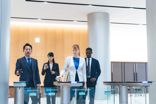 Group of multinational business people passing through a security gate