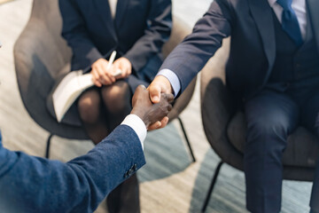 Group of multinational business people shaking hands in a lobby