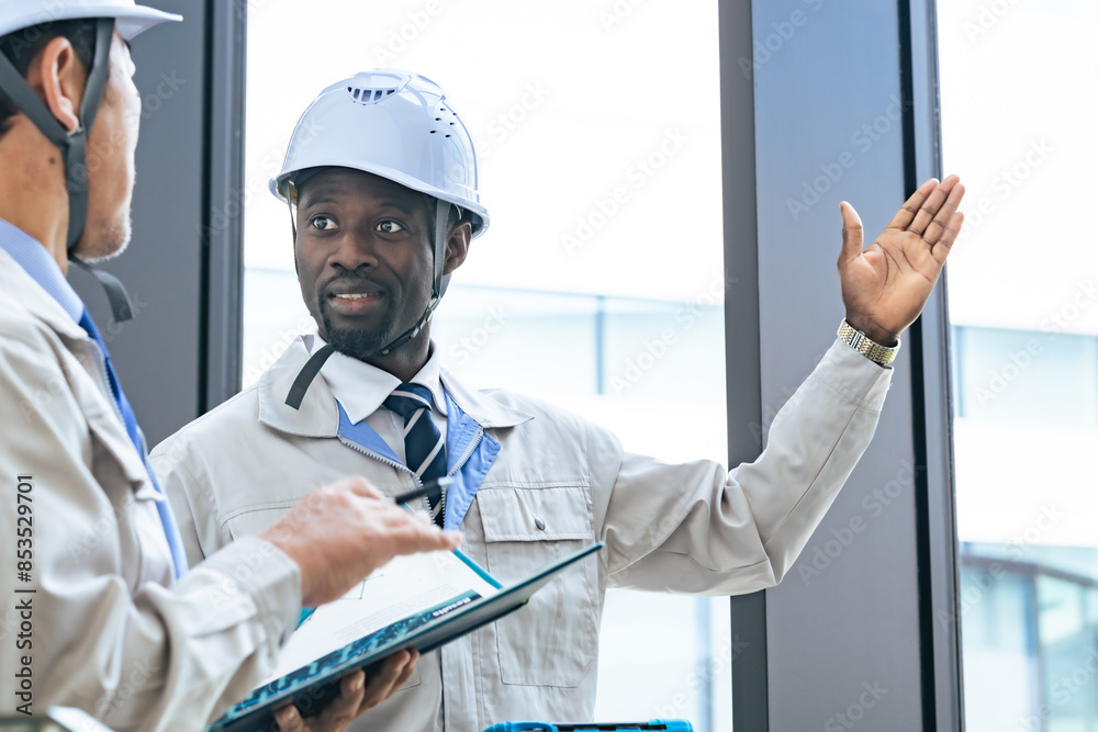 Poster group of multinational engineers having a conversation in a building