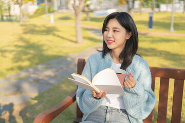 girl reading and studying on school compus