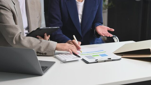 Businessman and team analyzing financial statement Finance task. with smart phone and laptop and  tablet.