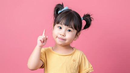 sweet Asian girl with pigtails looks turn fingers up having a idea