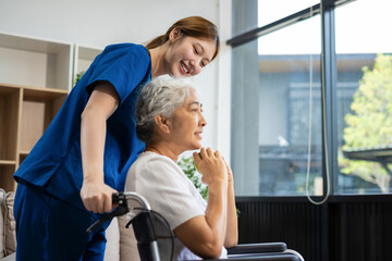 Obraz premium young caregiver assists her elderly woman patient at a nursing home. senior woman is assisted by a nurse at home.