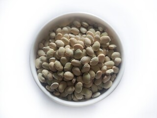 Legume seeds of lima beans or Lablab purpureus or Hyacinth beans. Fresh scattered seeds of Lablab purpureus or hyacinth beans. Kingdom- Plantae. Family- Fabaceae.