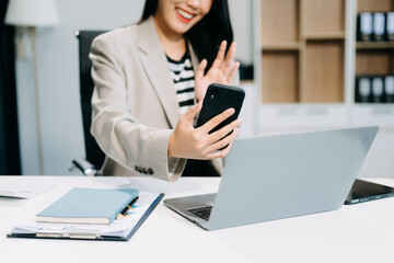 Business woman using tablet and laptop for doing math finance on an office desk, tax