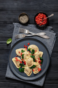 italian pasta mezzelune on a plate, top view