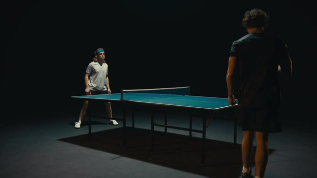 Two ping pong players in a match