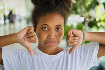 Upset African black Woman Expressing Disagreement with double two thumbs down hand Gesture, Wrong, Rejection, no way, no, bad, deny, refuse, disagree, dislike, Unhappy and Negative expression concept