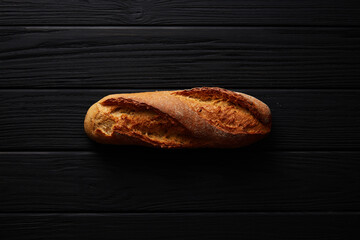 A French Baguette On A Black Background. 